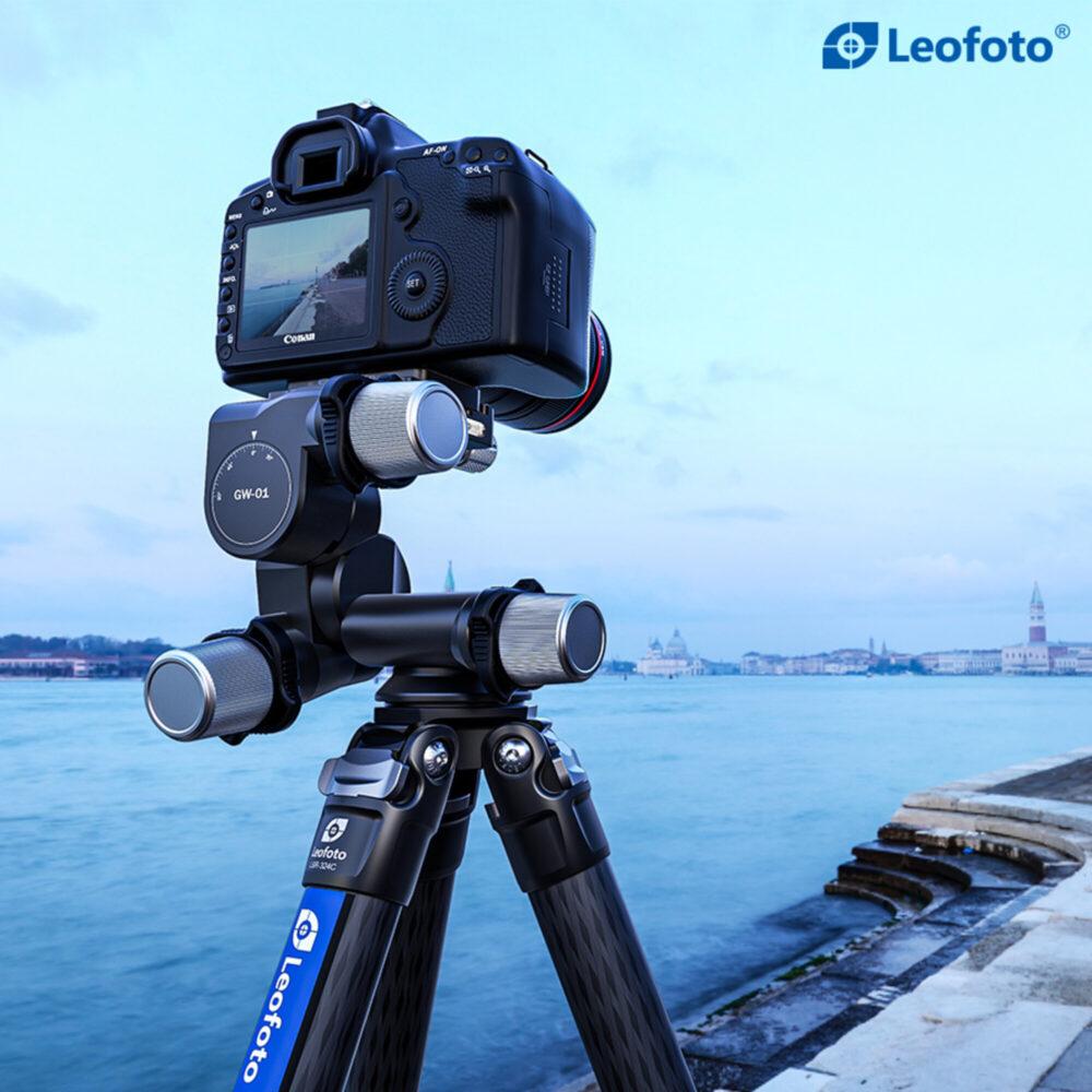 Leofoto GW-01 Statief-gearhead met camera op statief in portretstand gericht op hoge gebouwen langs het water.