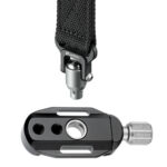 Leofoto DC-22Q snelkoppeling liggend naast draagriem met ingestoken QD-pin op witte achtergrond.