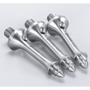 Leofoto S3/8 statiefvoet drie glanzende spikes schuin naast elkaar gelegd op neutrale ondergrond.