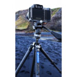 Leofoto LY-224C Tripod gebruikt op rotsachtige ondergrond bij water voor reis- en landschapsfotografie.