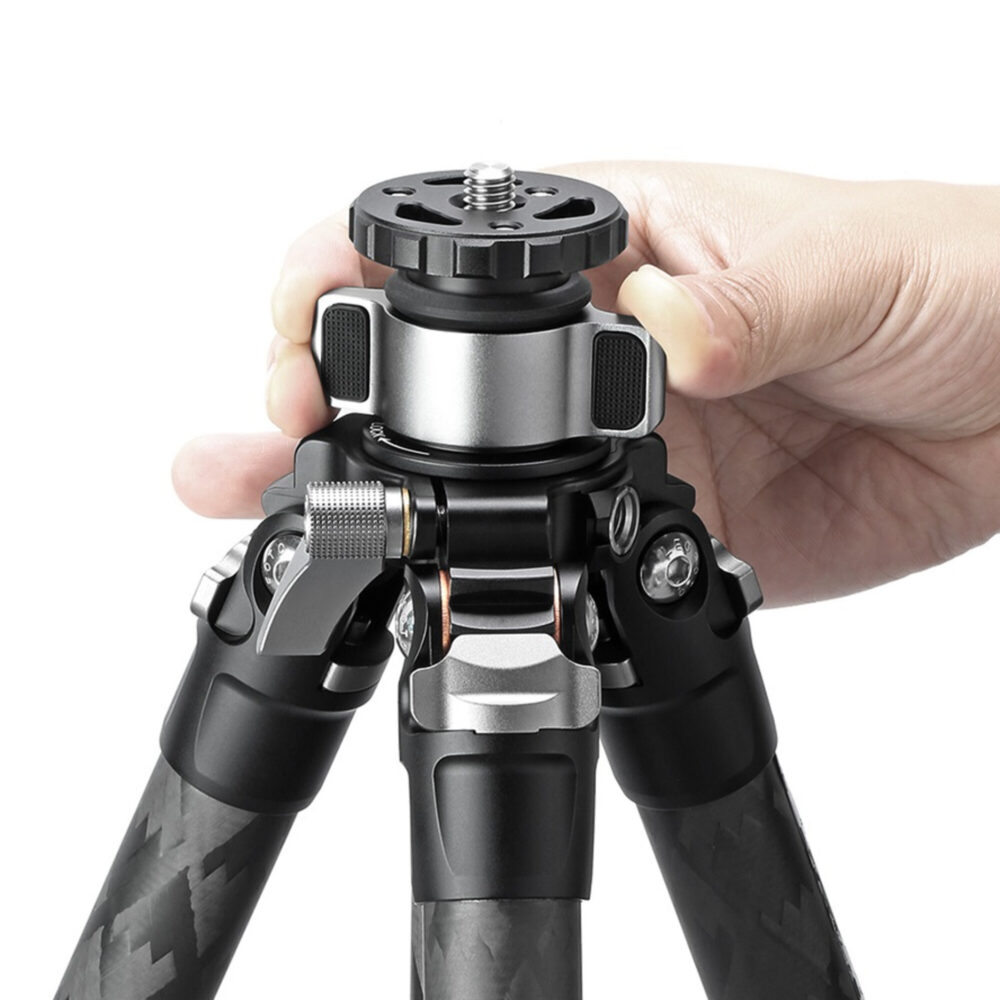 Leofoto LQ-324C Tripod close-up van hand die de vergrendelknop van de middenzuil bedient.