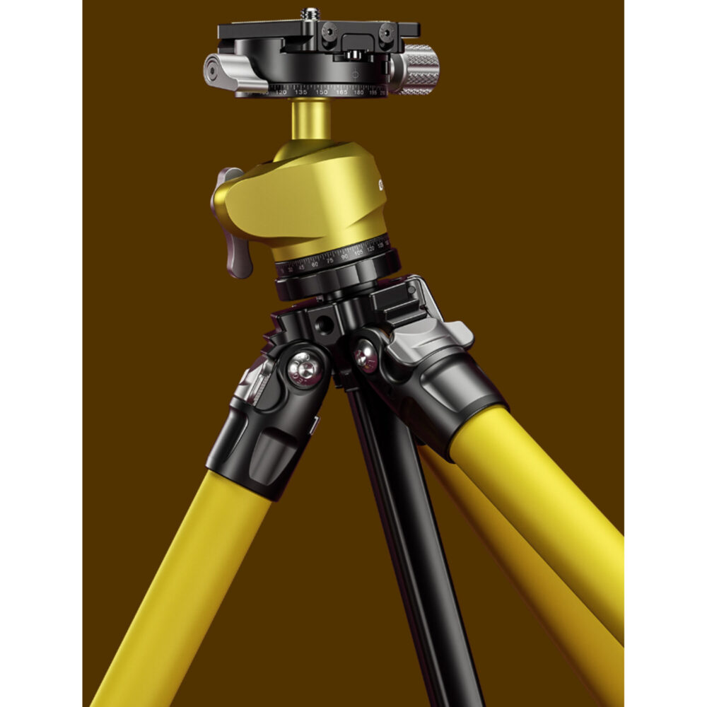 Leofoto LY-224C Tripod detail van scharnier en middenzuil met geel statiefbeen op bruine achtergrond.